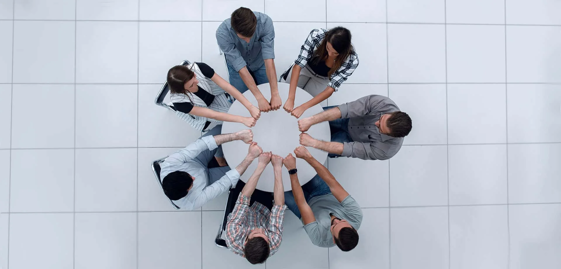 Team members in a circle holding hands
