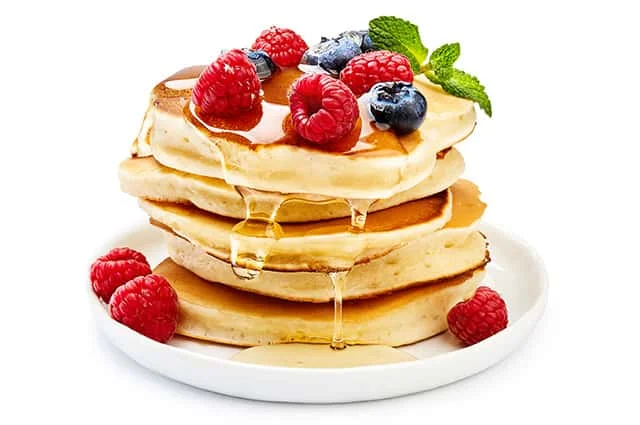 Coconut treacle spreaded over pancake with berries
